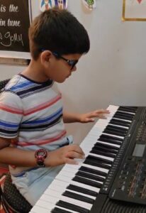 Anwit playing keyboard while preparing for RSL Debut exam – young pianist practicing melodies and scales.