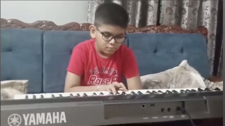 Focused shot of Anwit on keyboard, highlighting music practice and beginner-level piano performance