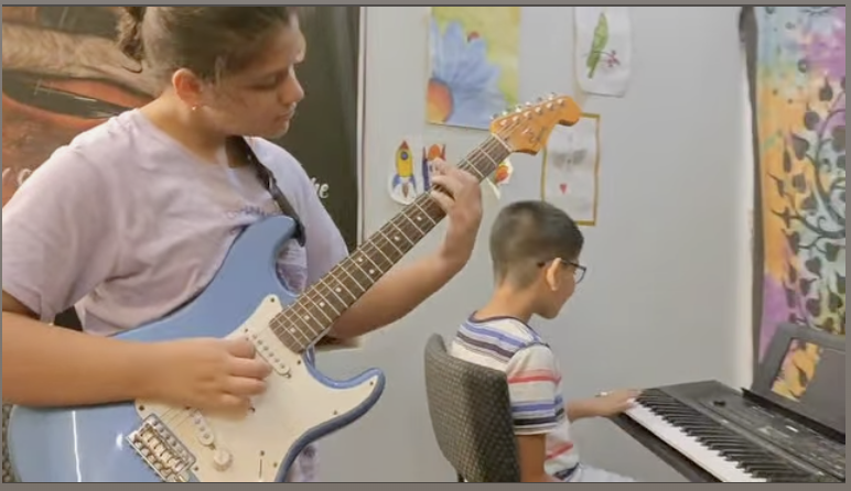 Gallery Musical Duo in Practice β Ishi on guitar & Anwit on keyboard, creating harmony together.