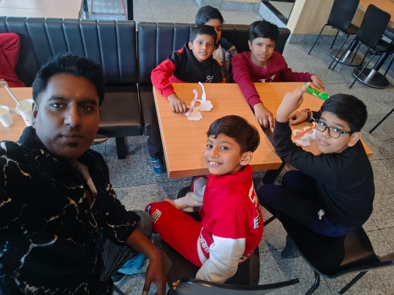 Young musicians Anwit and friends having fun with their mentor at McDonald’s