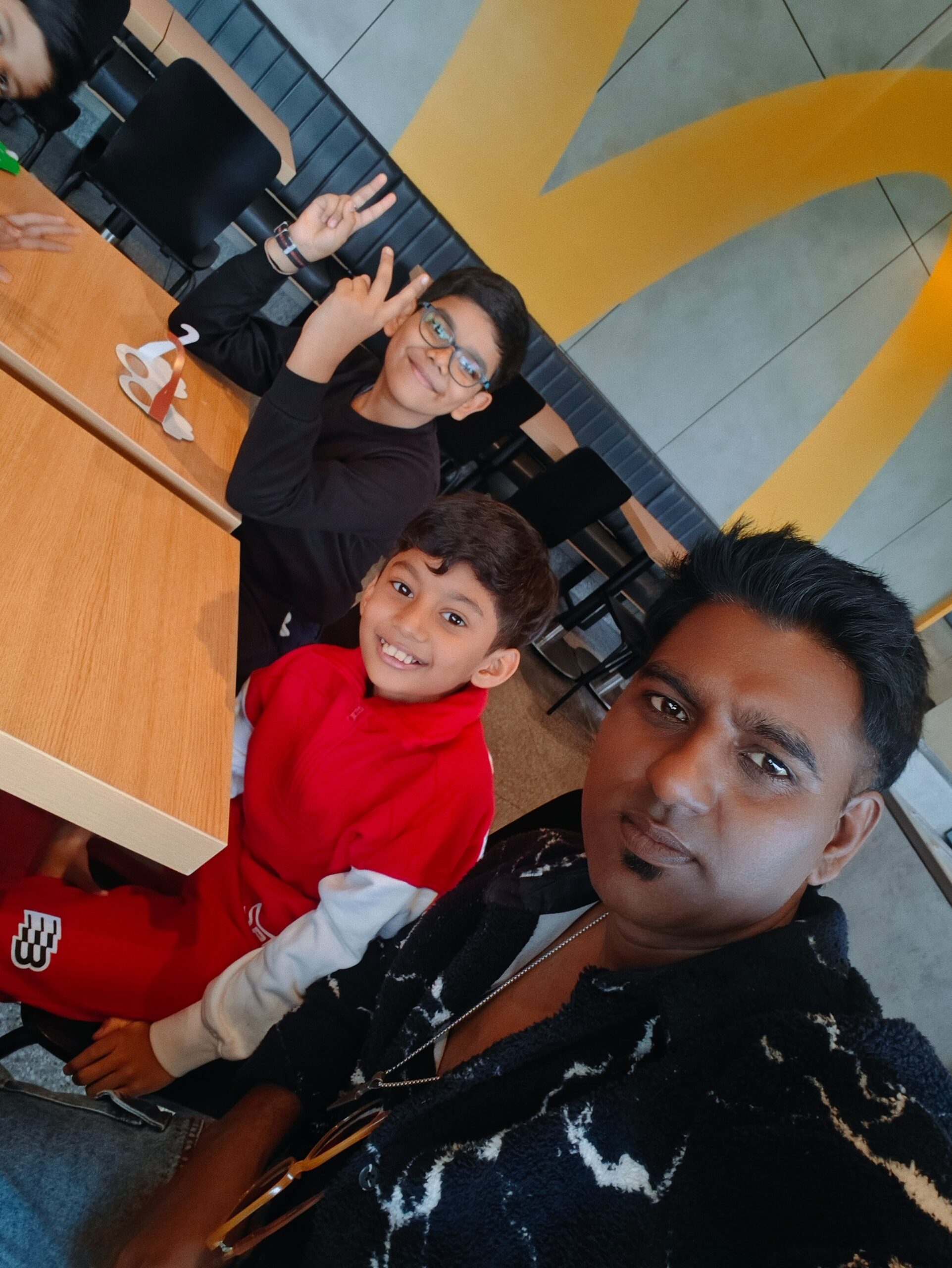 Anwit and peer group laughing and bonding with their mentor over food at McDonald’s