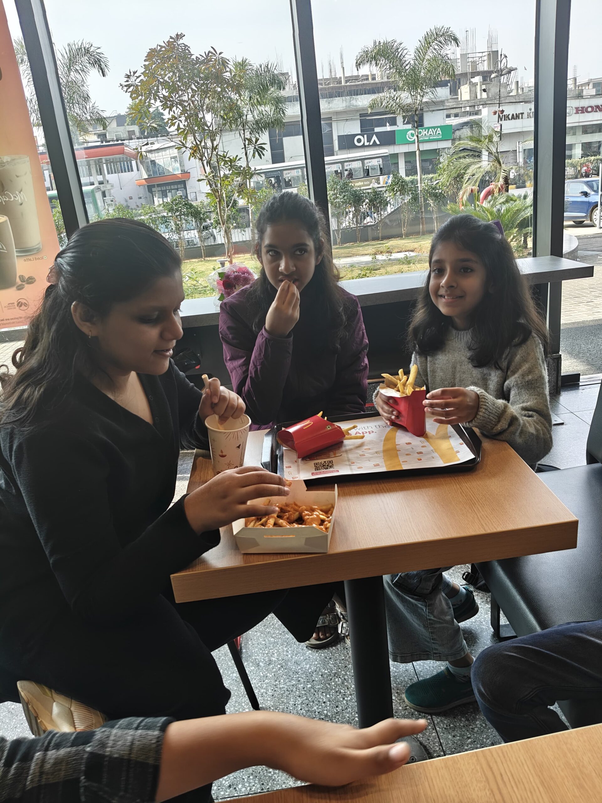 Teen Ishi laughing and enjoying time with friends at McDonald’s