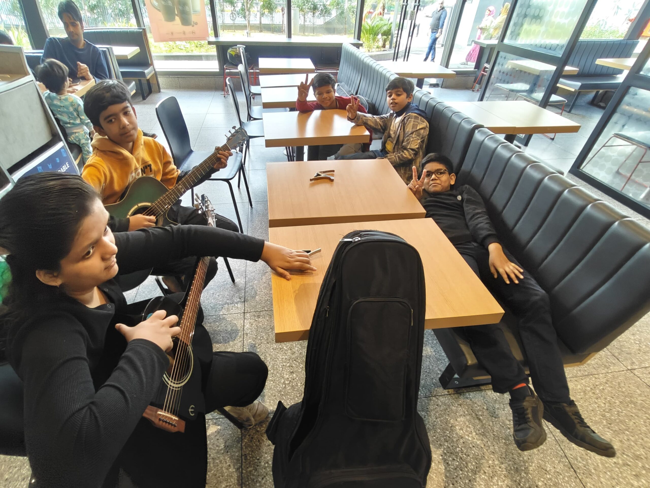Teen musicians brainstorming ideas for a song while at McDonald’s