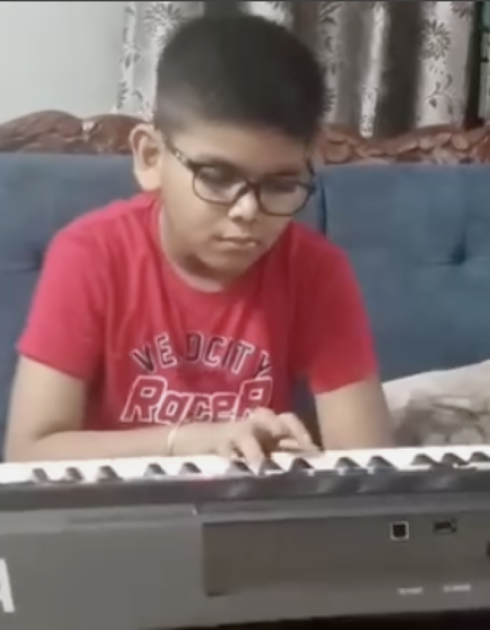 Focused shot of Anwit on keyboard, highlighting music practice and beginner-level piano performance