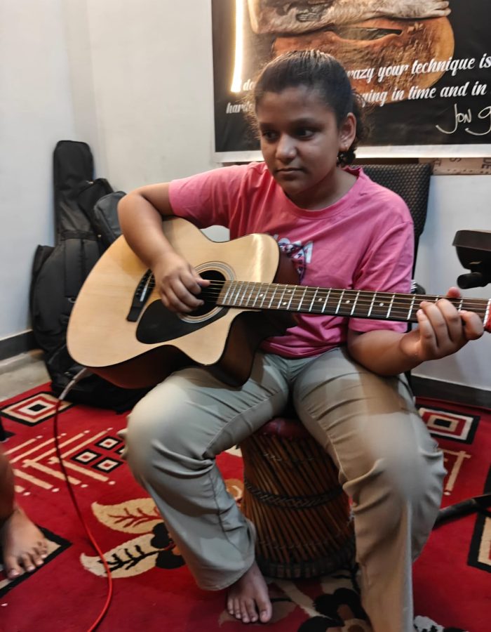 Ishi delivering soulful acoustic guitar melodies with precision, rhythm, and artistic expression.